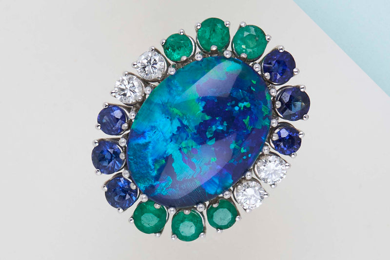 18ct. White Gold Ring - Doublet Opal - 6 Sapphires - 6 Emeralds - 4 Diamonds - Size 56