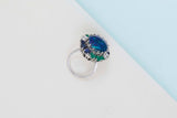 18ct. White Gold Ring - Doublet Opal - 6 Sapphires - 6 Emeralds - 4 Diamonds - Size 56